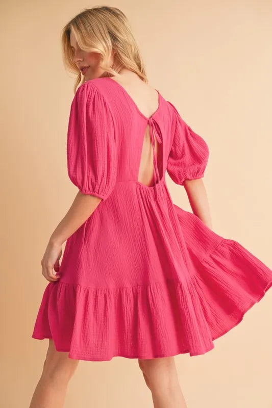Short sleeve mini dress with tied back and ruffle details, made from 100% cotton, ideal for casual summer wear.