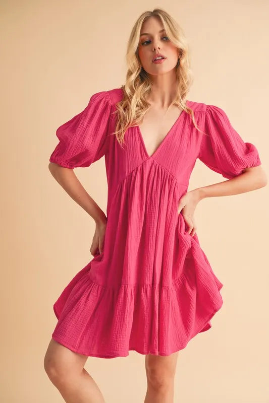 Short sleeve mini dress with tied back and ruffle details, made from 100% cotton, ideal for casual summer wear.